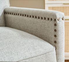 an upholstered couch with buttons on it