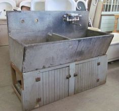 an old metal sink sitting on top of a table