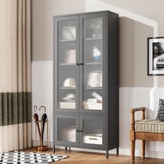 a tall gray cabinet with glass doors in a living room