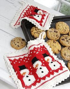 some cookies are on a tray and one cookie is in the shape of an oven mitt