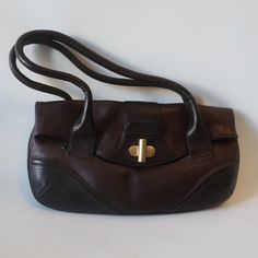 Nwd Womens Kenneth Cole Dark Brown Leather Shoulder Handbag * Color: Dark Brown Gold-Toned Hardware Flap W/ Twist Lock Closure 1- Main Compartment 1- Interior Zipper Pocket 1- Front Slip Pocket Keychain Hook Double Shoulder Strap Handle Material: Leather Measurements: Depth: 1.4" Height: 8.2" Base Width: 15.5" Strap Drop: 7.8" Includes Original Dust Bag Nwd, The Flap Where The Straps Lie Have Indent Marks On The Flap (See Pics) Otherwise; New With Defect. (Bag Uu).. Jms_farl(Up)-4** Trendy Formal Bag With Snap Closure, Leather Tote Shoulder Bag With Fold Over Clasp, Office Brown Shoulder Bag With Snap Closure, Brown Office Bag With Snap Closure, Brown Bag With Fold Over Clasp For Daily Use, Brown Bags With Fold Over Clasp For Everyday, Office Brown Satchel With Fold Over Clasp, Elegant Brown Satchel With Snap Closure, Formal Brown Shoulder Bag With Snap Closure