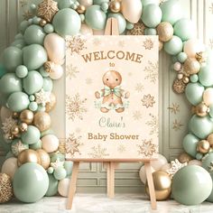 a welcome baby shower sign surrounded by balloons and snowflakes in pastel colors