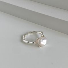 "Embrace timeless elegance with the Baroque Beauty Adjustable Ring. This exquisite piece, meticulously crafted from the finest 925 Sterling Silver, is the epitome of sophistication, showcasing a large natural freshwater Baroque pearl at its center. Secured in a four-prong setting, the pearl, with its unique size of approximately 11mm by 9mm, commands attention, illuminating this baroque pearl ring with its radiant glow. The pearl's distinctive contours, coupled with its unmatched luster, elevate Elegant Rings With Simple Design, Elegant Silver Midi Rings For Gift, Minimalist Pearl Ring For Wedding, Elegant Sterling Silver Stackable Rings, Elegant Midi Rings With Simple Open Ring Design, Elegant Silver Stackable Rings For Gifts, Elegant Midi Rings With Simple Design, Elegant Silver Stackable Rings As Gift, Elegant Open Band Rings With Simple Design