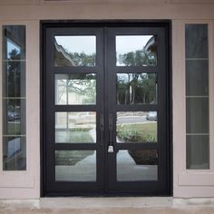 a black double door with glass panels on the front and side doors are open to let in light