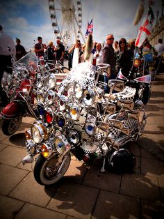 a group of motorcycles parked next to each other in front of a carnival ferris wheel