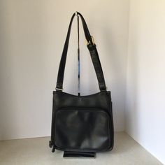 "This Liz Claiborne Black Faux Leather Shoulder Bag is in very good vintage condition. The exterior of the bag is black faux leather. The interior of the bag is lined with solid black cotton fabric. The interior main section has one zippered pocket, with a flap closure. There is one exterior slip pocket. In addition, there is an additional zip around section. This section contains two slip pockets, four card holders, and three pen holders. This bag measures approximately: Length: 9.25\" Height: Vintage Black Satchel With Zipper Closure, Classic Black Shoulder Bag With Zipper Pocket, Vintage Black Bag With Zipper Pocket, Black Vintage Bag With Zipper Pocket, Vintage Black Shoulder Bag With Leather Backing, Black Formal Satchel With Zipper Pocket, Timeless Bags, Black Cotton Fabric, Amanda Smith