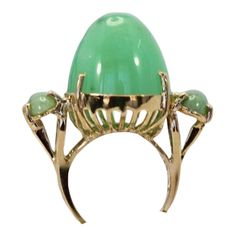 This is part of Chairish’s Fine Jewelry assortment.  18K Bullet Chalcedony and Jade 3 Stone Ring in Yellow Gold  This gorgeous 18K Bullet Chalcedony and Jade 3 Stone Ring in Yellow Gold is unique and you will not see another one. This ring is 19.31 high and deep and 17.67 round.  Furthermore, the Jade stones are approximately 0.75 carats each with a weight of 14.5 grams.  Bullet stones are very rare especially in this size. Do not wait. Green Cabochon Jewelry For Evening, Green Oval Jewelry For Evening, Elegant Green Opal Ring For Formal Occasions, Elegant Green Opal Ring, Unique Cabochon Emerald Ring For Formal Occasions, Elegant Green Evening Rings, Elegant Green Opal Ring With Oval Cabochon, Luxury Jade Ring For Formal Occasions, Green Cabochon Jewelry For Party