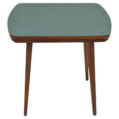 a small wooden table with a light blue seat on it's top and legs