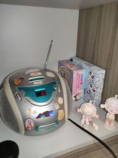 an alarm clock radio sitting on top of a counter next to toys and other items