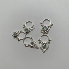 These are soooooo pretty. Made is 925 sterling silver with tribal details, set with a shiny bright aquamarine stone. The rings are all 1cm (.40”) in diameter. The wire is 18 gauge.The back is open so light shines through and you can really see the color. Each piece is made BY HAND so there might be slight differences from the photo One of the images contains numbers to specify which you would like from the drop down menu. Unique Silver Aquamarine Jewelry, Unique Sterling Silver Body Jewelry In Silver, Silver Goddess, Grass Valley, Nose Rings, Nose Ring Stud, Aquamarine Stone, Tragus, The Rings