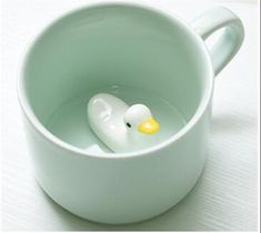 a white cup with a rubber duck in it