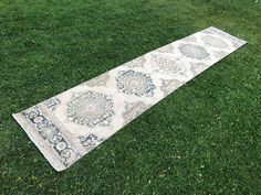 a rug laying on the grass in an open field