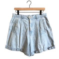 Vintage high waisted jean shorts by Regatta New York. Light blue sand blasted / sun bleached coloring, with vertical welt pockets at the front hip & one buttoned back flap pocket on the right side. Front hip lines are pleated to provide a roomy leg opening (30" diameter!) with back darts for shaping. Cuffed. Has five belt loops and a metal fly zipper & metal front button. Has absolutely huge pockets! See pictures for details. TAGGED SIZE Size 14* *NOTE: Vintage sizes run smaller than modern day. Tagged sizes are not always representative of contemporary sizing. Please refer to measurements below for true fit. Realistically this is closer to a contemporary size 12 / Large, so is categorized as such. MEASUREMENTS (lying flat) Waist: 16" Inseam: 4" Leg Opening, each: 15" Fly Length: 6" Front Washed Blue High Rise Relaxed Fit Jean Shorts, Relaxed Fit Washed Jean Shorts For Spring, Acid Wash High Rise Denim Shorts, Light Wash Washed Cutoff Shorts, Light Wash Cutoff Washed Shorts, Light Wash High Rise Washed Shorts, Faded Bottoms With Pockets For Summer, Relaxed Fit Faded Shorts For Spring, Light Wash Bleached Cotton Bottoms