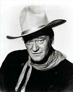 a black and white poster with a cowboy saying it is round here we only use john wayne toilet paper rough, tough, and don't take crap from no one