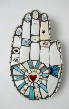 a stained glass hamsa with hearts and stars on it