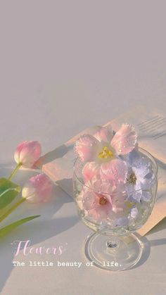 flowers are in a glass bowl on a table