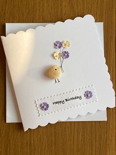 a birthday card with a bird and flowers on it