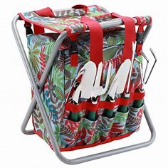 a red and green bag with utensils in it sitting on a metal rack