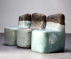 three small stools sitting next to each other on top of a cement flooring