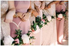 the bridesmaids are holding their bouquets together