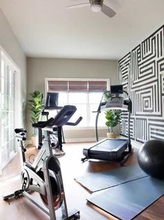 a home gym with exercise equipment and yoga mats