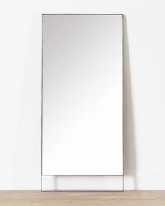 a mirror sitting on top of a wooden floor