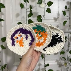 two crocheted coasters with halloween designs on them