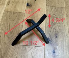 a wooden floor with measurements on it and a black object laying on the floor next to it