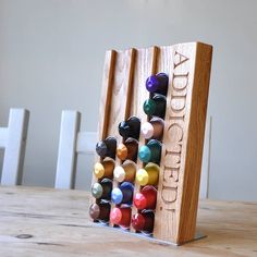 a wooden rack with colored crayons in it