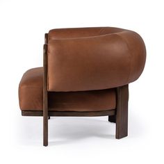 a brown leather chair sitting on top of a wooden frame