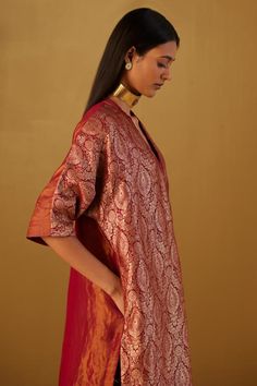 Red kaftan in Mughal brocade with floral patterns and minimal zardozi embroidery. Comes with red cotton silk pant.
Components: 2
Type Of Work: Floral
Neckline: V Neck
Sleeve Type: Three Quarter
Fabric: Kurta: Brocade and Handloom tissue, Pant: Cotton Silk, Lining: Shantoon
Color: Red
Other Details: 
Lace trims
2 pockets on kaftan and pant
Partially elasticated waistband
Length:
Kaftan: 41 inches
Pant: 36 inches
Model height: 5ft 9inches, wearing size M
Note: Dupatta worn by the model is not for Red Kaftan With Kimono Sleeves For Festive Occasions, Brocade Dupatta With Dabka For Festive Occasions, Festive Brocade Dupatta With Dabka Details, Festive Brocade Dupatta With Dabka, Bollywood Style Brocade Dupatta With Dabka, Bollywood Brocade Dupatta With Dabka, Festive Red Kaftan With Kimono Sleeves, V-neck Traditional Wear For Eid, Traditional Drape Kurta For Rituals