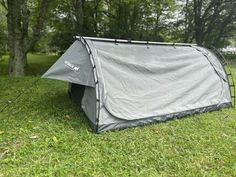 a tent is pitched up in the grass