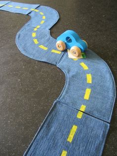 a toy car is on the road made out of denim