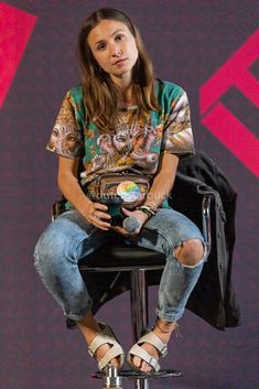 a woman sitting on top of a black chair