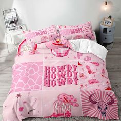 a bed with pink giraffes on it and the words howdy howdy