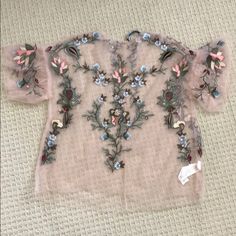 Never Been Worn Zara Sheer Shirt With Embroidery. Love The Shirt But Never Had A Chance To Wear It. The Embroidery Details Are Gorgeous. Material Is 100% Viscose. Has A Button In The Back (Comes With Back Up Button). Size Small. Festive Floral Embellished Summer Top, Pink V-neck Top With Floral Embroidery, Pink Feminine Embroidered Blouse, Pink Embroidered Feminine Blouse, Bohemian Floral Embroidered Fabric For Spring, Floral Embroidered Short Sleeve Blouse For Party, Elegant Pink Tops With Floral Embroidery, Spring Embroidered Crew Neck Blouse, Spring Tops With Tonal Embroidery And Short Sleeves