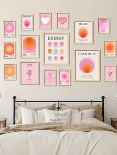 a bedroom with pink and orange art on the wall above the bed, along with pillows