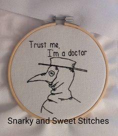 a cross stitch hoop with a drawing of a bird wearing a hat and the words trust me i'm a doctor on it