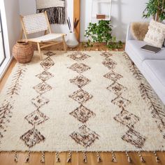 a living room with a couch, chair and rug