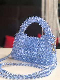 A soft blue beaded bag is an elegant accessory that attracts the eye with its delicate shade of blue and the shine of the beads. It is made from high quality materials, creating a sophisticated and sophisticated look. This bag is perfect for special occasions when you want to add a touch of luxury and femininity to your look. Bridesmaid Gift Bags, Bridesmaid Bags, Beaded Bag, Beaded Bags, Elegant Accessories, Bags Purses, Bridesmaids Gifts, Beautiful Bags, Gift Bags