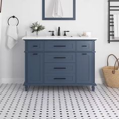 a bathroom with a sink, mirror and towel rack on the wall next to it