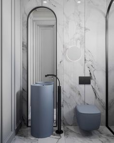 a bathroom with marble walls and flooring next to a round mirror on the wall