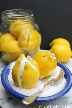 some lemons are sitting on a plate with sugar