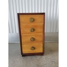 a wooden cabinet with three drawers and brass knobs