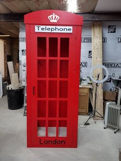 a red phone booth sitting inside of a building