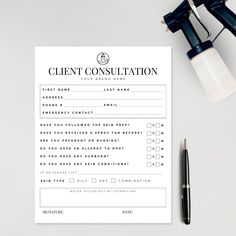 a client's consulting form next to a pair of eyeglasses and a pen