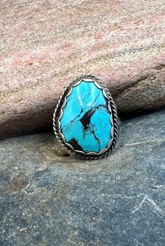 Vintage Navajo Handmade Sterling Silver Natural Blue Kingman Turquoise Ring 7.75 Orders totaling $100 and up include an anti-tarnish treated velvet jewelry pouch!  Ring is a size 7.75 and can be resized by your local jeweler Face of ring measures approximately 1 1/8" X 7/8" Weighs approximately 9 grams Condition: Pre-owned Metal: Sterling silver No stamp, electronically tested with a Niton DXL precious metal analyzer to guarantee sterling silver Comes in a gift box! This item is in used condition and will exhibit the expected surface scratches and dings to the silver from normal wear.  Take a look at our other rings! https://www.etsy.com/shop/OnceUponAGemJewelers/items?section_id=21598191 Or visit our store to see all our treasures! https://www.etsy.com/shop/OnceUponAGemJewelers?ref=seller Western Style Turquoise Ring, Southwestern Style Turquoise Inlay Ring, Southwestern Style Turquoise Ring With Large Stone, Southwestern Turquoise Ring With Large Stone, Southwestern Style Large Stone Turquoise Ring, Collectible Bohemian Turquoise Ring, Bohemian Oval Turquoise Collectible Ring, Untreated Blue Turquoise Western Ring, Western Style Turquoise Ring Collectible