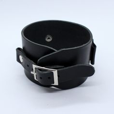 Johnny Depp style wide leather watchband adjustable by single buckle. This bracelet can be use as a wrist tattoo cover, besides it's suitable for most existing wristwatches. Before buy please measure your watch in 2 dimensions (see last picture in listing) and choose lug size you need. Between keepers we can add hole with diameter 20 or 26 mm for smart watch works right. To find other colors - check our items ( we will add new photos soon), on the photo - glossy black color. Suitable for standar Classic Black Bracelets With Wrist Strap, Classic Black Bracelet With Wrist Strap, Adjustable Black Watch Band With Wrist Strap, Adjustable Black Leather Belt Bracelet, Black Leather Punk Wristband, Classic Black Adjustable Watch Bands, Adjustable Black Wrist Strap Watch Accessories, Black Adjustable Wrist Strap For Watch, Black Adjustable Wrist Strap Watch Accessories