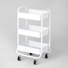 a white plastic cart with four shelves on each side and two black wheels, against a gray background