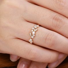 a woman's hand with a diamond ring on it